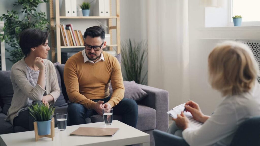 A compassionate medical provider discussing treatment plans with an emotionally drained patient under a Ketamine Treatment for Clinical Depression in Bloomington, Minnesota sign.