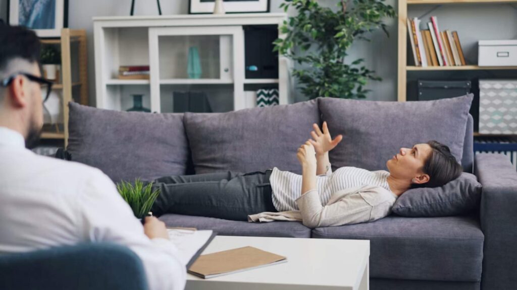 Here are a few descriptive alt tag options for an image of a person lying on a sofa during a session, incorporating your exact keyword: Option 1 (Detailed & Descriptive) A patient rests comfortably on a sofa during a supportive clinical session highlighting Ketamine Treatment for Rapid Suicidal Ideation in Bloomington, Minnesota.