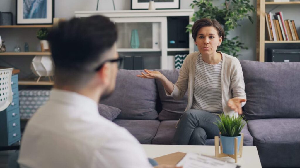 A healthcare provider explaining medication to a woman during an Oral Ketamine Treatment in Bloomington, Minnesota session at Psychiatric Pathways.